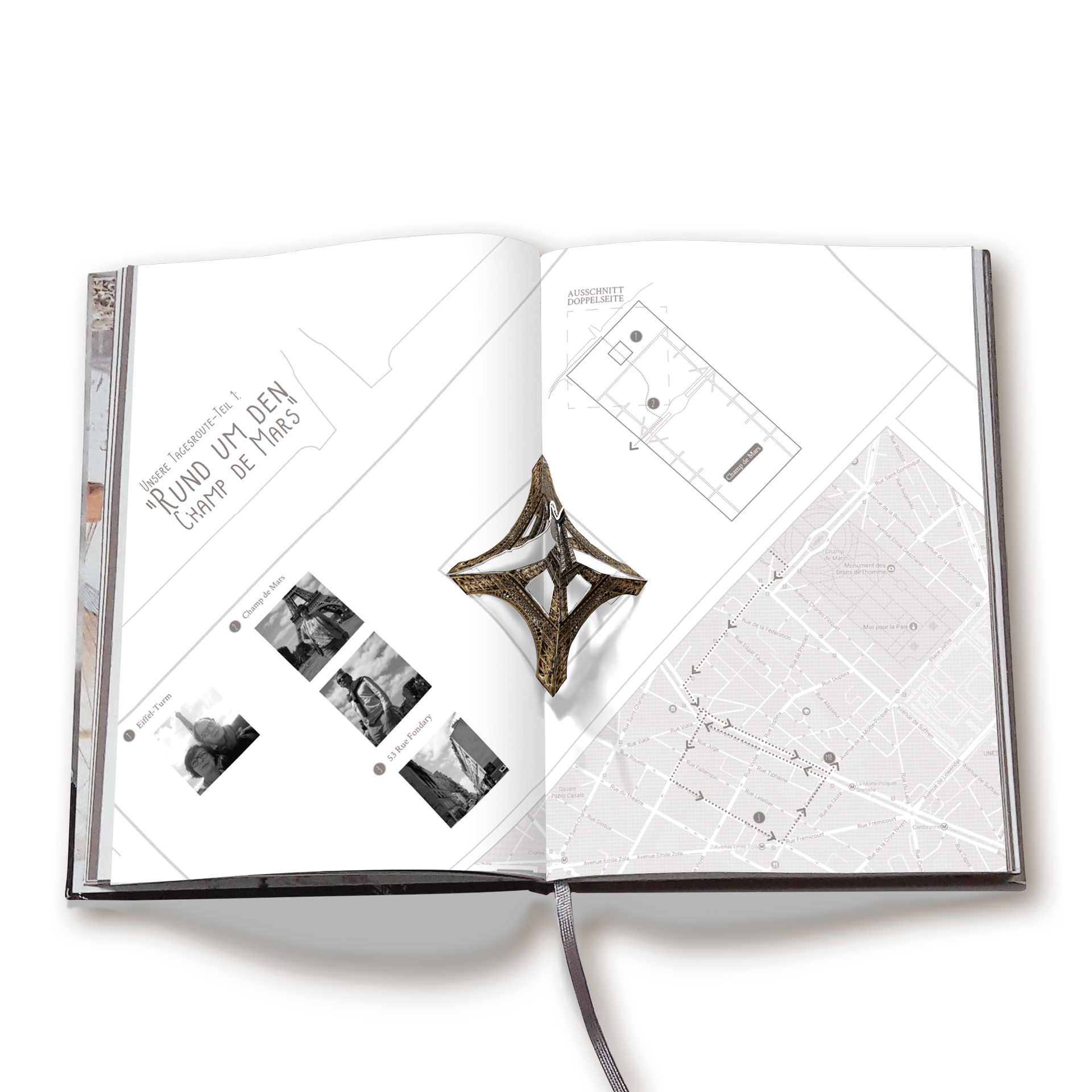 Reisebuch Paris. Man sieht ein aufgeschlagenes Buch mit dem illustrierten Champs de Mars und als Aufsteller den Eiffelturm aus Papier